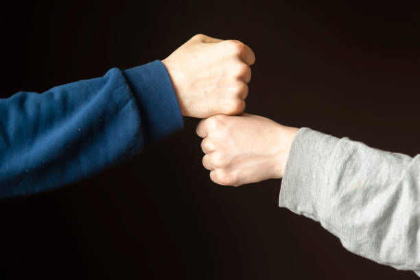 istock Fist bump or Knuckle bump between two friends f 1124618465