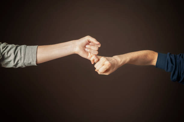 istock two men hold their little fingers and make peace d s 1124618466