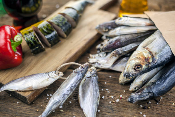 istock Dry fish on wooden background with beer, 1124619658