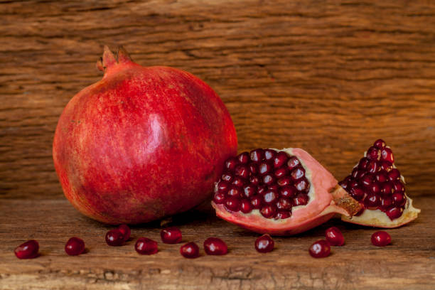 istock pomegranate and grains  on the old wooden board 1124619721