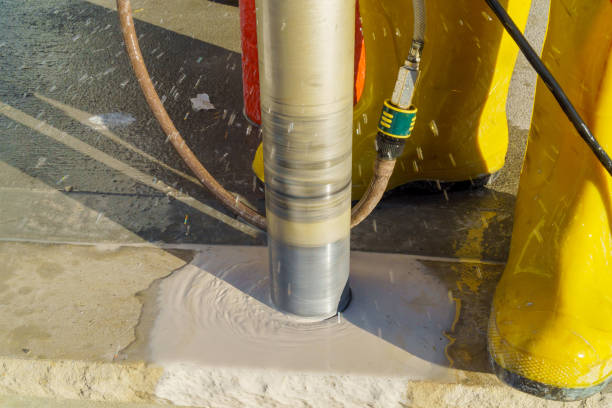 istock Drills a hole in a concrete a hole in a large gray stone 1124620989