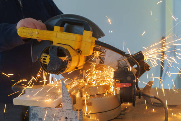 istock Craftsman sawing metal with disk grinder in workshop. 1124620992