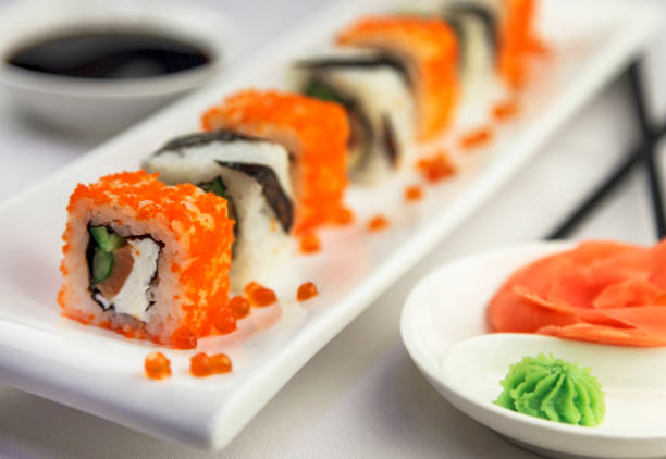 istock Sushi rolls with tuna and green onions on White background 1124621690