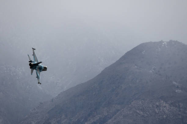 istock Fighter jet maneuvering in a hazy winter sky 1124621876