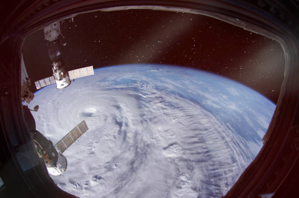 hurricane is seen from spaceship porthole. the elements of this image furnished by nasa. - window porthole sky cloudscape imagens e fotografias de stock