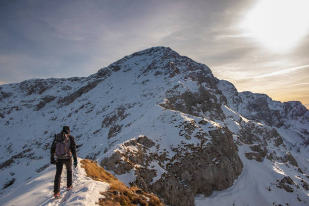 istock Alpinist walking on mountain snowy 1124629074