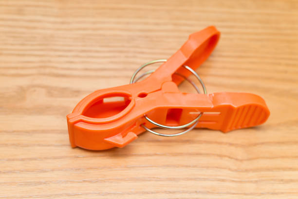 istock orange clothespin on a wood background 1124629103