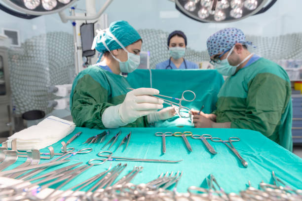 istock Surgeons in full surgical gear during operation 1124630720