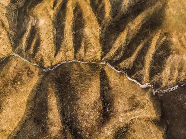 Directly Above View of Arid Land Forms Frozen brook in a dry and cold landscape dry riverbed stock pictures, royalty-free photos & images