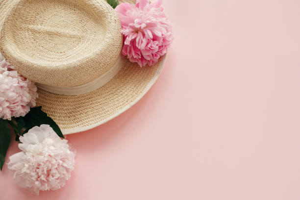 istock Straw hat with white and pink peonies on pastel pink paper. Hello spring image with copy space. Summer vacation concept. International Women's Day. Happy mothers day 1124634699