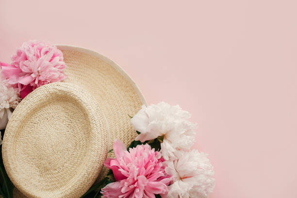 istock Hello spring image with copy space. Summer vacation concept. Straw hat with white and pink peonies on pastel pink paper, flat lay.  International Women's Day. Happy mothers day 1124635410