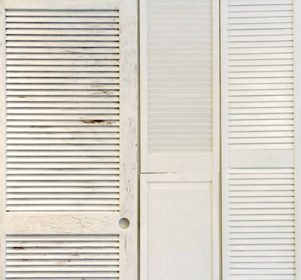 istock White Wooden Shutters on the Wall 1124637183