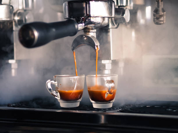 istock Two glasses of coffee cup and coffee machine makers selective focus. 1124638112