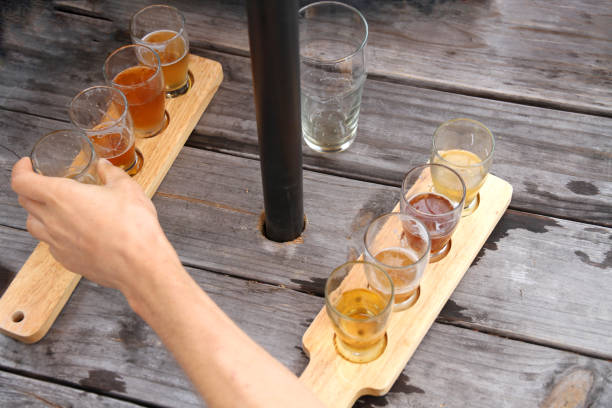 Hand Reaching for a Beer on Picnic Table