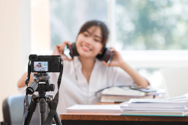 istock Happy Asian woman videoblog / blogger vlogger recording online course or tutorial coach presentation pass video for teaching live homework sharing online channel social media by mirrorless camera 1124642138