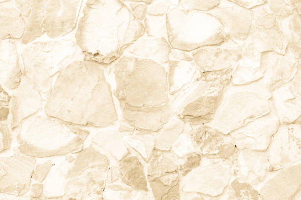 Seamless Brown stone wall pattern of decorative. Seamless Brown stone wall pattern of decorative cream slate surface of modern style design decorative uneven cracked realmasonry wall of multicolored stones or blocks with cement or sandstone. architectural exterior marble stone wall texture stock pictures, royalty-free photos & images