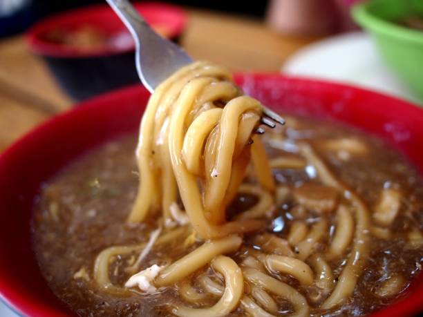 istock Bowl of freshly cooked fat egg noodles in thick soup 1124644185