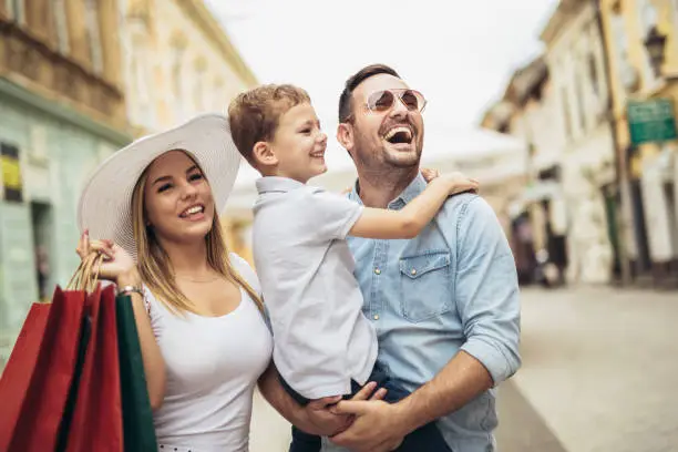 Photo of Happy family having fun outdoor after shopping