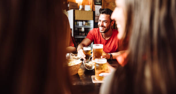istock people talking and drinking in a pub with the beers 1124646416