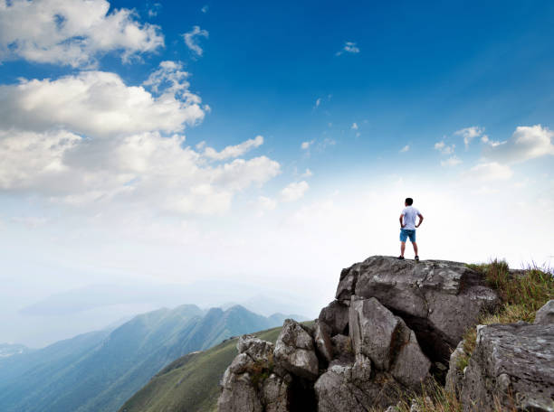 istock Man standing on the top of mountain 1124646697