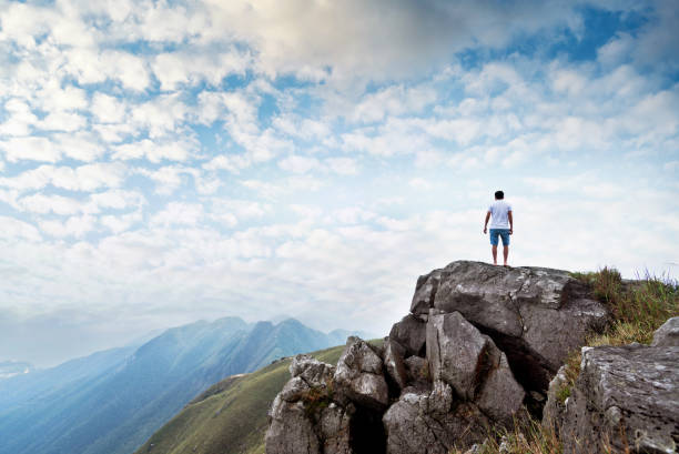 istock Man standing on the top of mountain 1124646737