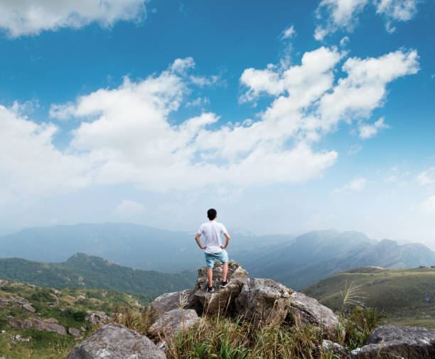 istock Man standing on the top of mountain 1124646860