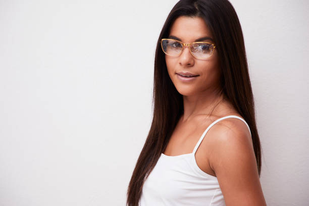 Beautiful woman in glasses looking at camera