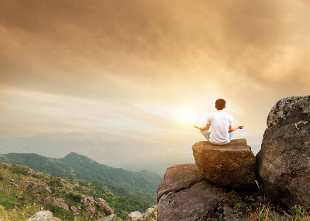 istock Man doing yoga on top of mountain 1124647852