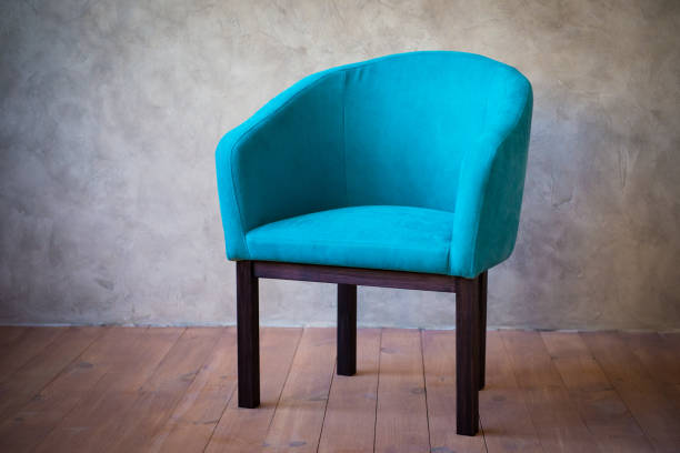 istock Blue chair against a gray wall. Interior 1124648761
