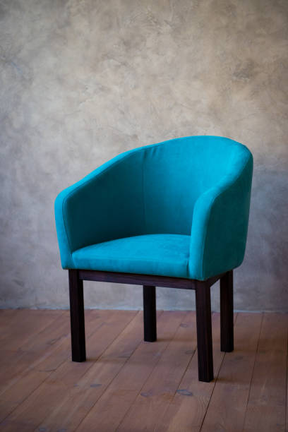 istock Blue chair against a gray wall. Interior 1124648915