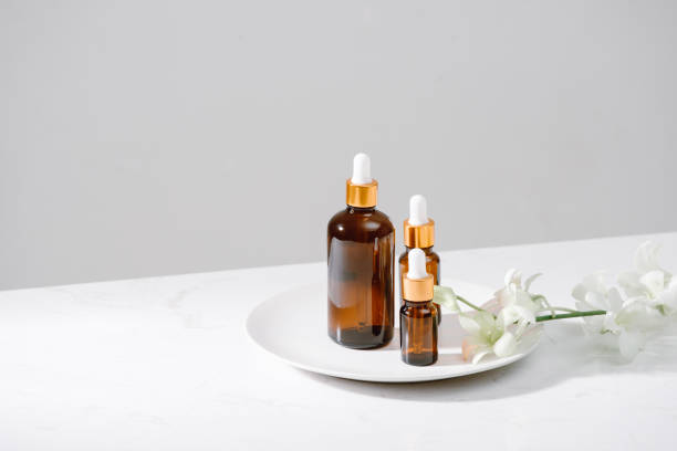 istock Spa setting with orchids and essential oil in a glass bottle, aromatherapy concept 1124648990