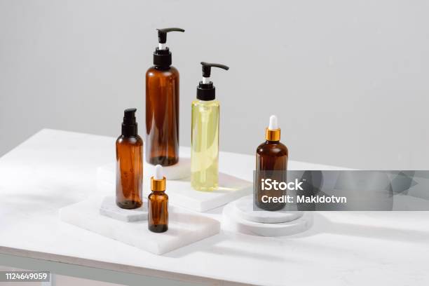 Spa Cosmetics In Brown Glass Bottles On Gray Concrete Table Copy Space For Text Beauty Blogger Salon Therapy Branding Mockup Minimalism Concept Stock Photo - Download Image Now