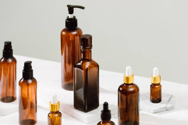 istock Spa cosmetics in brown glass bottles on gray concrete table. Copy space for text. Beauty blogger, salon therapy, branding mockup, minimalism concept 1124649190