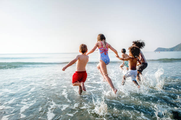 istock Kids running at the beach 1124649543