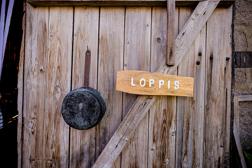 Loppis (flea market) sign at the entrance of a barn used as a sales hall for antiques