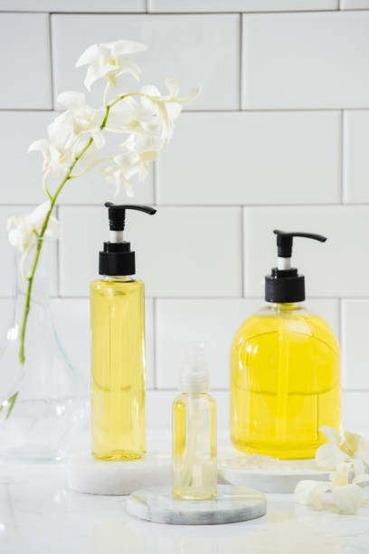 istock bottle of aroma essential oil with orchid on table, spa concept. 1124650926