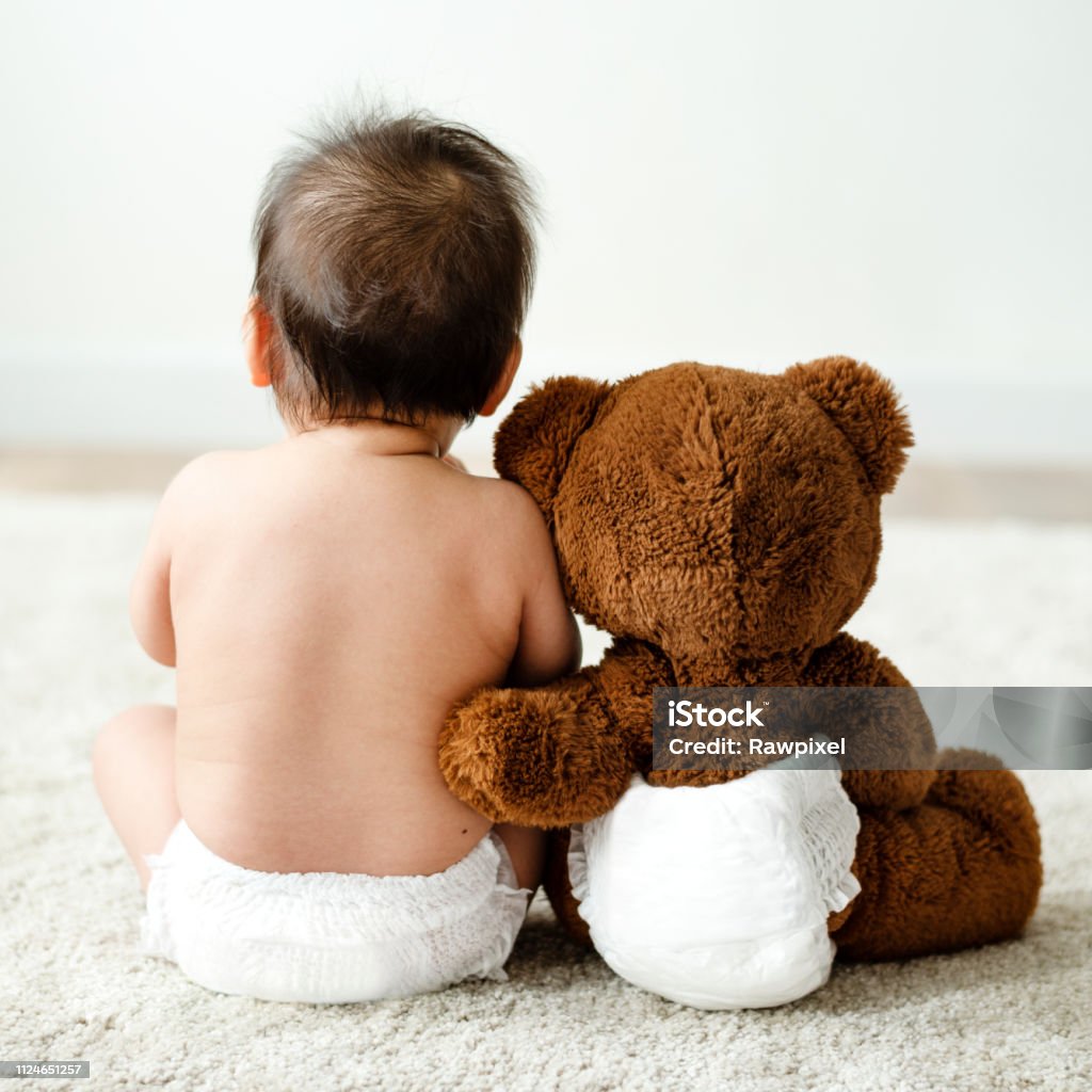 Back of a baby with a teddy bear Baby - Human Age Stock Photo