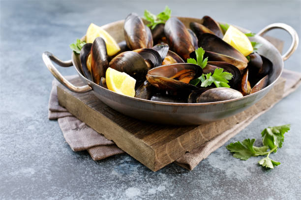 istock Mussels in cooking dish with parsley and lemon 1124653116