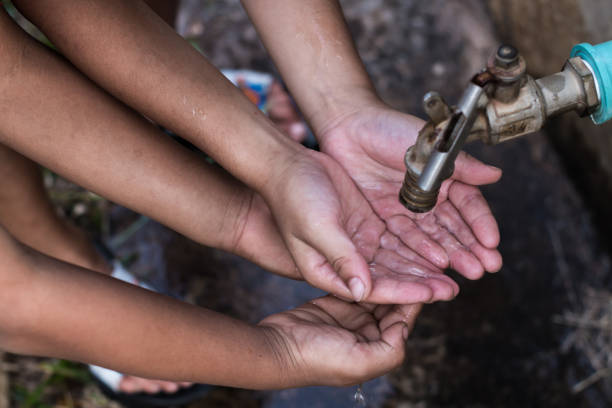 istock Cropped Hands Of Children Below Tap 1124653207