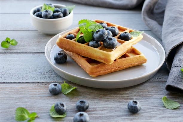 istock Traditional Brussels waffles with blueberries and honey 1124654020