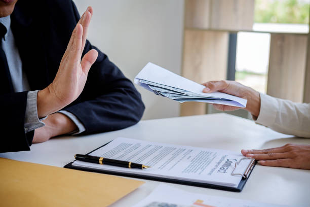 istock Businessman refusing money in the envelope to agreement contract, Bribe and corruption concept 1124654293