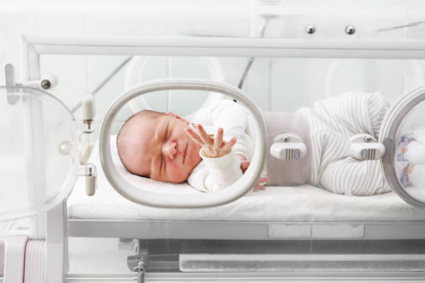 Newborn baby in an incubator.
