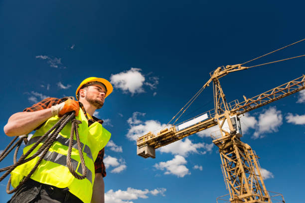 istock Manual Worker Wearing Hardhat And Reflective Clothing Working At Construction Site During Sunny Day 1124656806