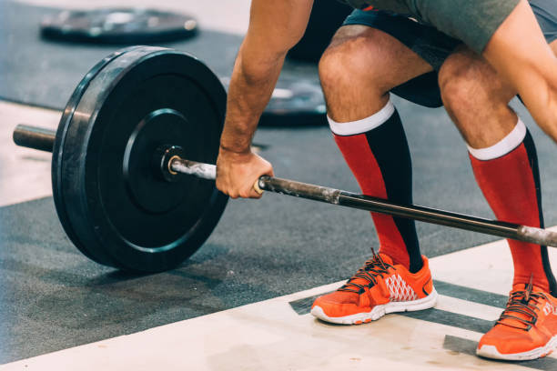 istock Low Section Of Man Holding Barbell In Gym 1124657675