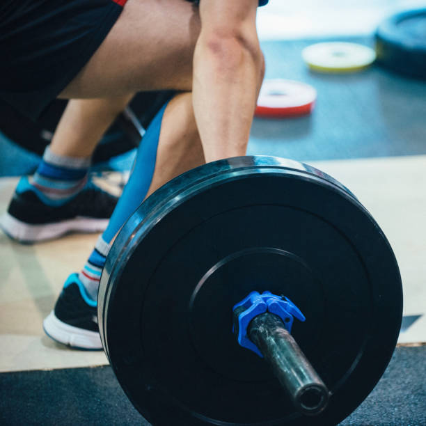 istock Low Section Of Man Holding Barbell In Gym 1124658187