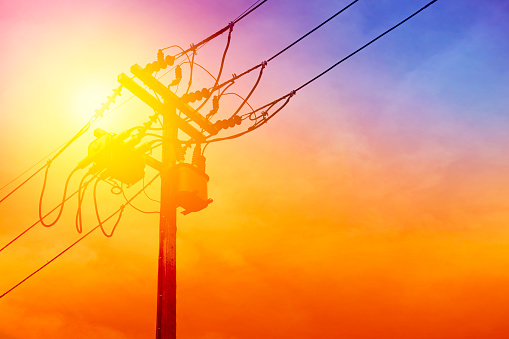 silhouette transformer, sunset electric wire on the pole in the evening