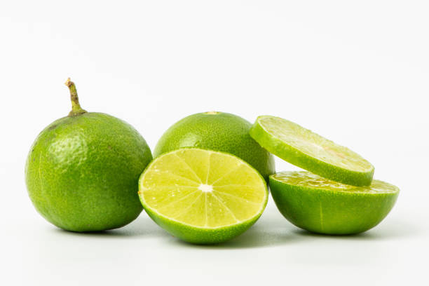 istock Limes with slices isolated on white background 1124663040