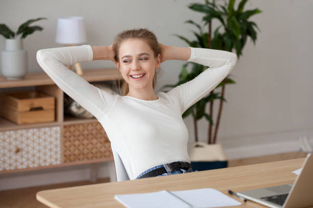 istock Happy satisfied female student relaxing finished work study at home 1124667497