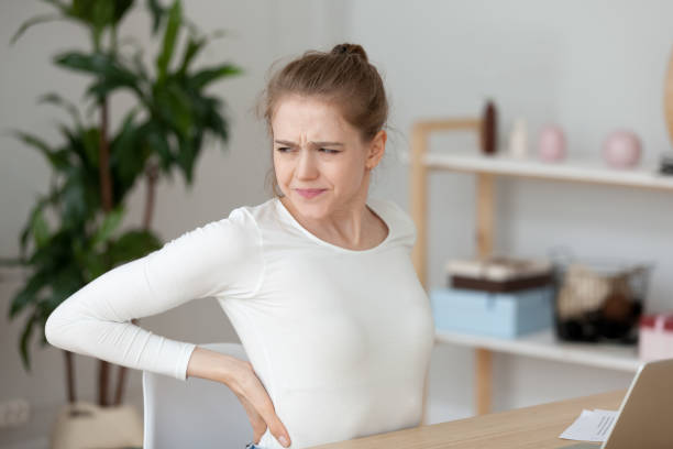 istock Tired girl feeling back pain rubbing muscles after sedentary work 1124667561