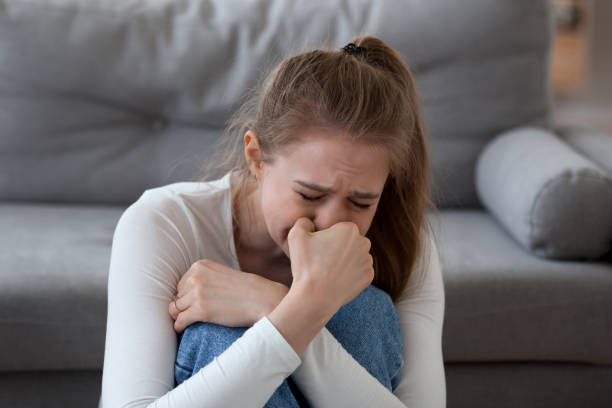 Desperate upset teen girl victim crying alone at home Desperate upset teen girl victim crying alone at home, sad abused young woman in tears feeling depressed heartbroken offended bad having problems, unexpected pregnancy, regret mistake abortion women crying stock pictures, royalty-free photos & images